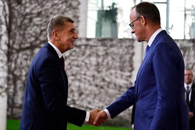 German Chancellor Friedrich Merz (R) and Czech Republic's Prime Minister Andrej Babis shake hands at the Chancellery in Berlin, Germany, on March 10, 2026. (Photo by Tobias SCHWARZ / AFP)