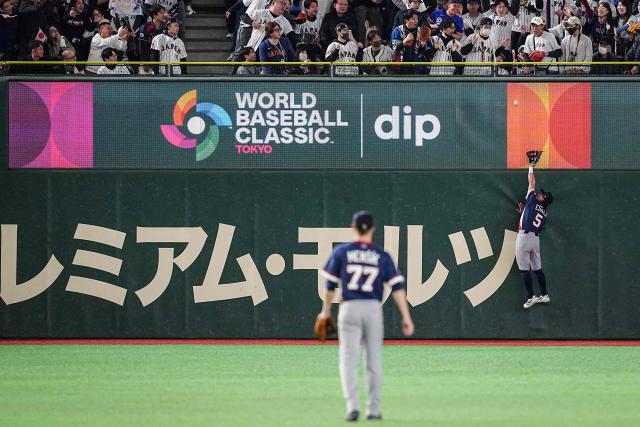 Czech Republic's William Escala (R) tries to catch a fly ball during the World Baseball Classic (WBC) Pool C game between Japan and Czech Republic at the Tokyo Dome in Tokyo on March 10, 2026. (Photo by Yuichi YAMAZAKI / AFP)