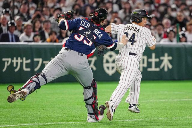 Japan's Masataka Yoshida (R) is tagged out by Czech Republic's Martin Cervenka during the World Baseball Classic (WBC) Pool C game between Japan and Czech Republic at the Tokyo Dome in Tokyo on March 10, 2026. (Photo by Yuichi YAMAZAKI / AFP)