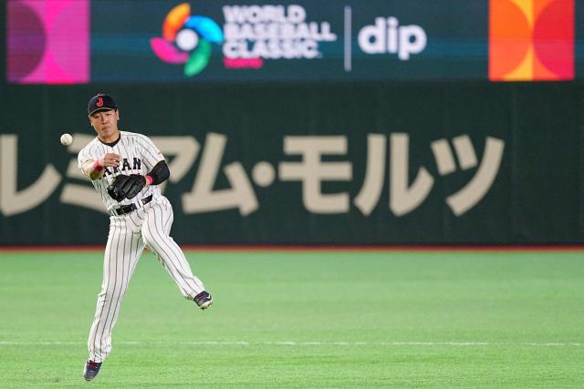 Japan's Kazuma Okamoto throws the ball to first base during the World Baseball Classic (WBC) Pool C game between Japan and Czech Republic at the Tokyo Dome in Tokyo on March 10, 2026. (Photo by Yuichi YAMAZAKI / AFP)