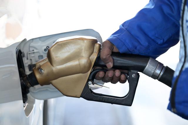 An employee refuels a car at a gas station in Kuwait City on March 10, 2026. The Iran war sent oil prices soaring on March 9, after Tehran marked the appointment of its new supreme leader with a new barrage of missiles targeting Israel and the Gulf energy industry. (Photo by YASSER AL-ZAYYAT / AFP) / Attention editors: AFP covers the war in the Middle East through its extensive regional network, including bureaus in Tehran, Jerusalem, and several neighboring countries. Since the start of the conflict, journalists have been working under increasingly restrictive conditions. Authorities in several countries have limited reporters' movements, photo and live video coverage from sensitive locations. Some governments and armed groups have banned images of missile or drone strikes and other security-related sites. / 