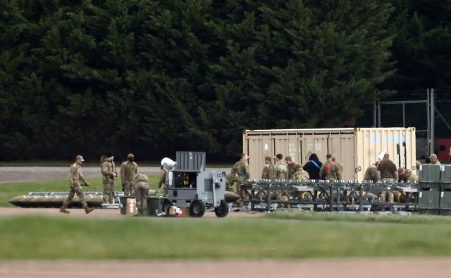 Members of the US Air Force (USAF) prepare munitions at RAF Fairford in south-west England on March 10, 2026, after USAF B-1 Lancer bomber jets and Air Force Boeing B-52 Stratofortress bombers landed at the RAF base. Fairford is one of two bases, along with the Diego Garcia facility in the Indian Ocean, that the UK has given the US permission to use for "specific defensive operations into Iran" to destroy Iranian missiles at source, the British defence minister said in a statement. (Photo by Henry NICHOLLS / AFP)