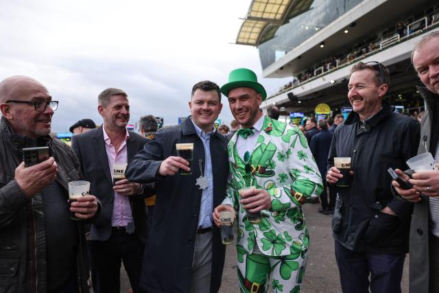 Racegoers attend the first day of the Cheltenham Festival at Cheltenham Racecourse, in Cheltenham, western England on March 10, 2026. (Photo by Adrian Dennis / AFP)