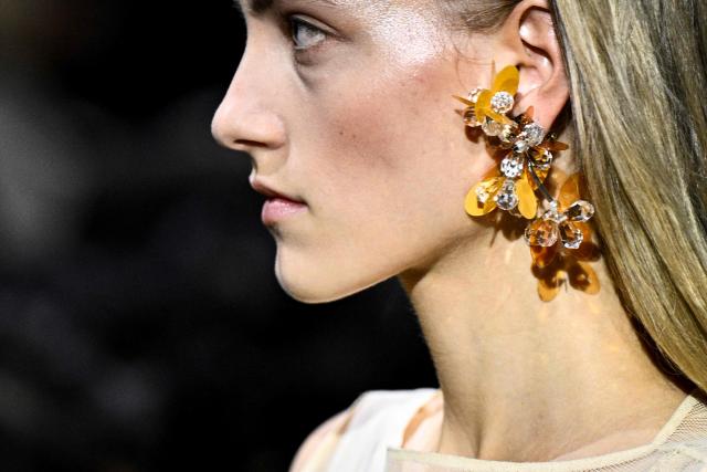 A model presents earings for Miu Miu for the Women's Ready to Wear Fall/Winter 2026-2027 collection fashion show as part of the Paris Women Fashion Week, in Paris, on March 10, 2026. (Photo by JULIEN DE ROSA / AFP)