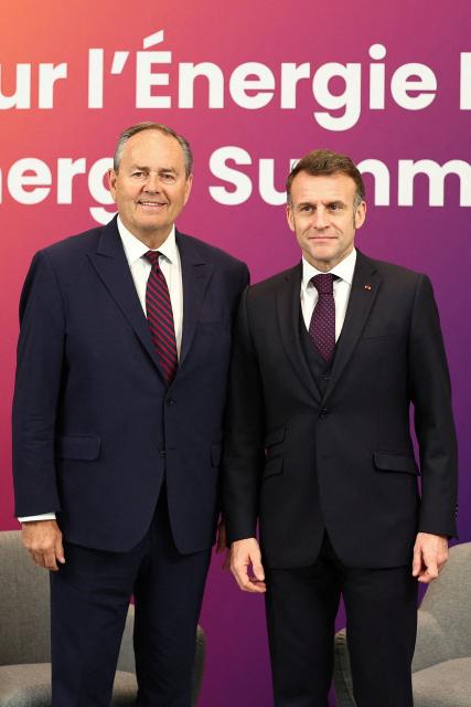 French President Emmanuel Macron (R) poses with the CEO of Cameco Timothy Gitzel (L) during the Nuclear Energy Summit at the Seine Musicale venue in Boulogne-Billancourt, outside Paris, on March 10, 2026. (Photo by Abdul Saboor / POOL / AFP)