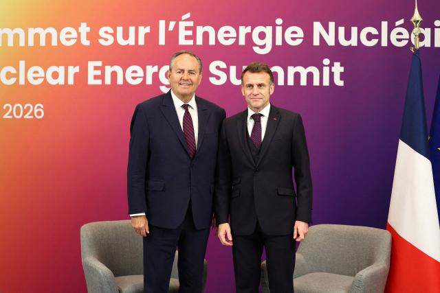 French President Emmanuel Macron (R) poses with the CEO of Cameco Timothy Gitzel (L) during the Nuclear Energy Summit at the Seine Musicale venue in Boulogne-Billancourt, outside Paris, on March 10, 2026. (Photo by Abdul Saboor / POOL / AFP)