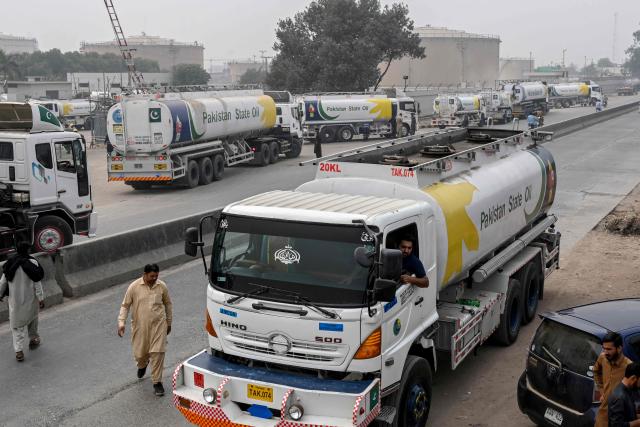 Pakistan State Oil tankers line up along a road before entering a fuel storage facility in Sheikhupura district in Lahore on March 10, 2026. Pakistan's Prime Minister Shehbaz Sharif on March 9 unveiled a raft of austerity measures designed to save fuel, as oil prices soar due to the US-Israeli war on Iran. (Photo by Arif ALI / AFP)