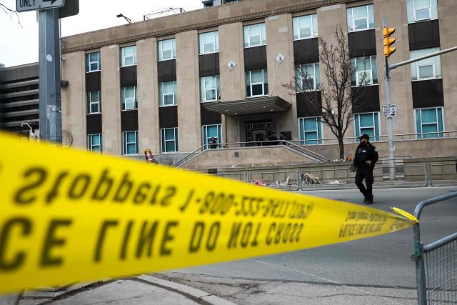 Toronto Police officers work around the scene of a shooting at the US Consulate in Toronto, Canada, on March 10, 2026. Shots were fired at the US consulate in Toronto early Tuesday but no one was injured, police said, days after Middle East war protests outside the building. The Toronto Police Service said it received reports of a firearm being discharged at the consulate before dawn in the downtown area of Canada's largest city. (Photo by Cole BURSTON / AFP)