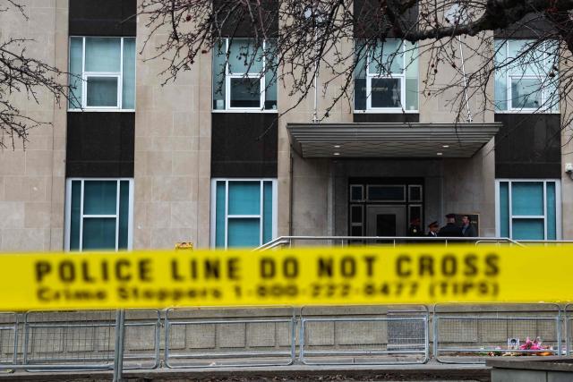 Toronto Police officers work around the scene of a shooting at the US Consulate in Toronto, Canada, on March 10, 2026. Shots were fired at the US consulate in Toronto early Tuesday but no one was injured, police said, days after Middle East war protests outside the building. The Toronto Police Service said it received reports of a firearm being discharged at the consulate before dawn in the downtown area of Canada's largest city. (Photo by Cole BURSTON / AFP)