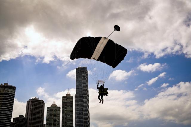 A skydiver descends near the Cinta Costera in Panama Bay, in Panama City, on March 10, 2026 (Photo by Martin BERNETTI / AFP)