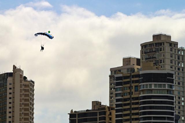 A skydiver descends near the Cinta Costera in Panama Bay, in Panama City, on March 10, 2026 (Photo by Martin BERNETTI / AFP)