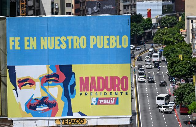 Aerial view of a billboard depicting ousted Venezuela's President Nicolas Maduro reading "Faith in our people", is seen in Caracas on March 10, 2026. (Photo by Juan BARRETO / AFP)