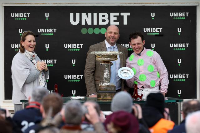 Jockey Paul Townend (R) poses with the trophy after riding Lossiemouth to win the Unibet Champion Hurdle Challenge Trophy horse race on the first day of the Cheltenham Festival at Cheltenham Racecourse, in Cheltenham, western England on March 10, 2026. (Photo by Adrian Dennis / AFP)