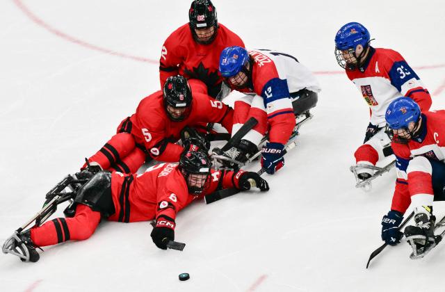 Canada's Tyler McGregor fights for the puck during the ice hockey match between Czech Republic and Canada at the Milano Cortina 2026 Paralympic Winter Games in Milan on March 10, 2026. (Photo by Stefano RELLANDINI / AFP)