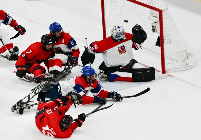 Canada's Vincent Boily shoots and scores during the ice hockey match between Czech Republic and Canada at the Milano Cortina 2026 Paralympic Winter Games in Milan on March 10, 2026. (Photo by Stefano RELLANDINI / AFP)