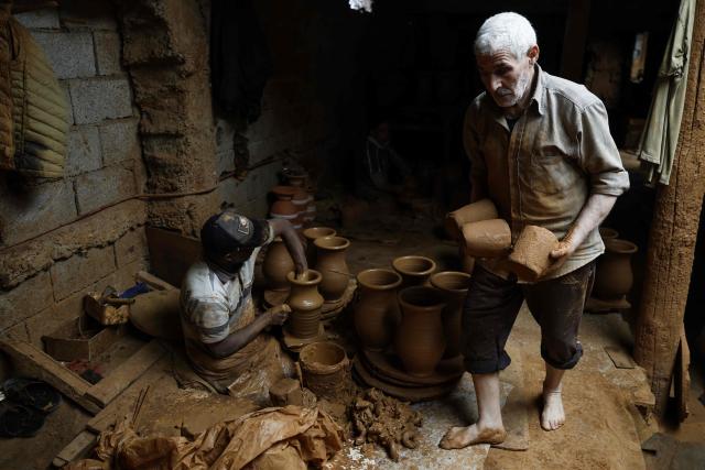 TOPSHOT - Artisans work on traditional pottery in a factory in Rabat on March 10, 2026. (Photo by Abdel Majid BZIOUAT / AFP)