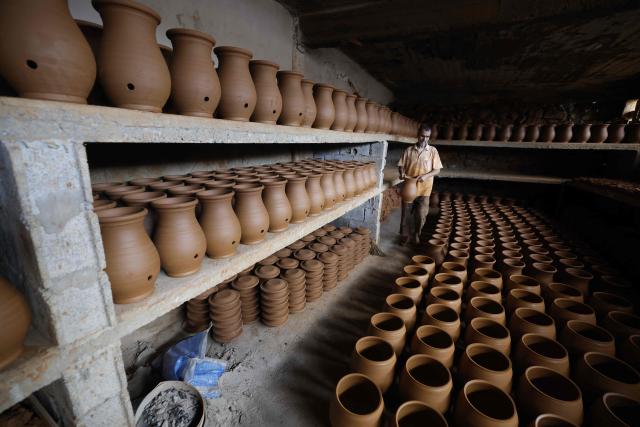 An artisan works on traditional pottery in a factory in Rabat on March 10, 2026. (Photo by Abdel Majid BZIOUAT / AFP)