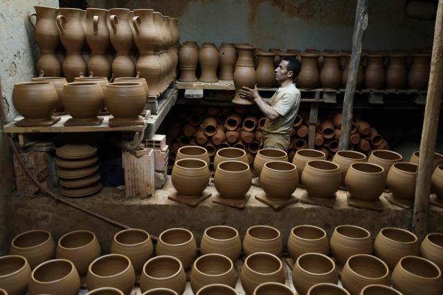 An artisan works on traditional pottery in a factory in Rabat on March 10, 2026. (Photo by Abdel Majid BZIOUAT / AFP)