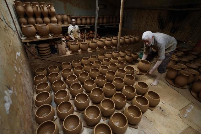 Artisans work on traditional pottery in a factory in Rabat on March 10, 2026. (Photo by Abdel Majid BZIOUAT / AFP)