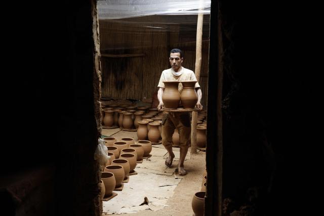 An artisan works on traditional pottery in a factory in Rabat on March 10, 2026. (Photo by Abdel Majid BZIOUAT / AFP)