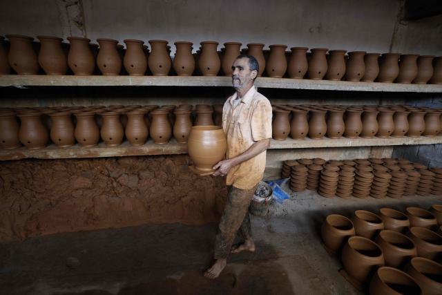 TOPSHOT - An artisan works on traditional pottery in a factory in Rabat on March 10, 2026. (Photo by Abdel Majid BZIOUAT / AFP)
