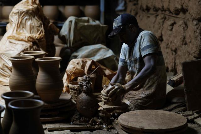 An artisan works on traditional pottery in a factory in Rabat on March 10, 2026. (Photo by Abdel Majid BZIOUAT / AFP)