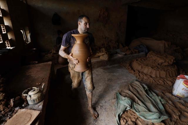 An artisan works on traditional pottery in a factory in Rabat on March 10, 2026. (Photo by Abdel Majid BZIOUAT / AFP)