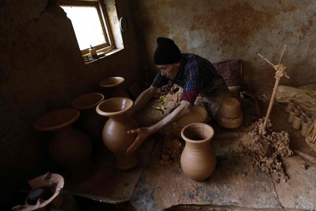 An artisan works on traditional pottery in a factory in Rabat on March 10, 2026. (Photo by Abdel Majid BZIOUAT / AFP)