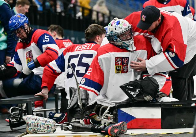 Czech Republic goalkeeper Patrik Sedlacek is congratulated by a teammate during the half time of the ice hockey match between Czech Republic and Canada at the Milano Cortina 2026 Paralympic Winter Games in Milan on March 10, 2026. (Photo by Stefano RELLANDINI / AFP)