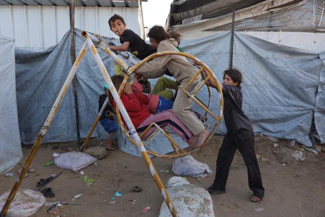 Displaced Palestinian children play on a swing at the Jabalia refugee camp in the northern Gaza Strip on March 10, 2026. The majority of Gaza's 2.4 million people have been displaced, often multiple times, by the war that began with Hamas's attack on southern Israel on October 7, 2023. With displaced families living in tented camps, a serious concerns has been raised over their living conditions. (Photo by Omar AL-QATTAA / AFP)