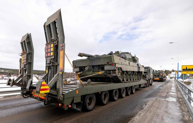 Swedish Leopard main battle tanks are transported across the border between Finland and Sweden to take part in the arctic military exercise Cold Response 26 in Pello, northern Finland, on March 10, 2026. Cold Response 26, led by Norway, brings 25,000 soldiers from 14 countries to Northern parts of Finland, Norway and Sweden to take part in the exercise which is part of NATO's enhanced presence, Arctic Sentry. The field training exercise in Finland involves soldiers from Finland, Sweden, the United States, France, Italy and the United Kingdom. (Photo by JARNO VUORINEN / various sources / AFP) / Finland OUT
