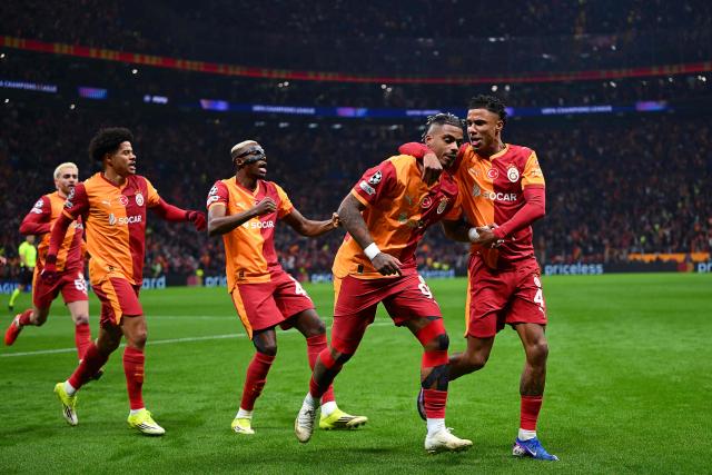 Galatasaray's Gabonese midfielder #99 Mario Lemina (2nd R) celebrates with teammates after scoring the opening goal during the UEFA Champions League round of 16 first leg football match between Galatasaray SK and Liverpool FC at the Ali Sami Yen Sports Complex in Istanbul on March 10, 2026. (Photo by YASIN AKGUL / AFP)