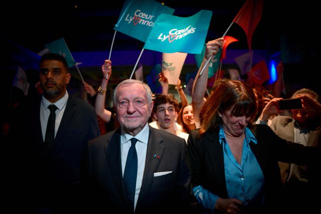 President of Business software publisher Cegid and Vice-President of French Football Federation (FFF) Jean-Michel Aulas (L) arrives to deliver a speech during a campaign rally for his candidacy in the Lyon municipal elections, in Lyon, central-eastern France, on March 10, 2026. (Photo by OLIVIER CHASSIGNOLE / AFP)