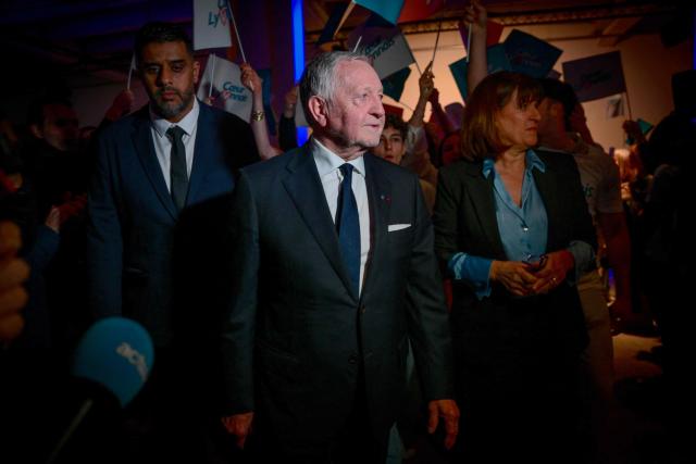 President of Business software publisher Cegid and Vice-President of French Football Federation (FFF) Jean-Michel Aulas (C) arrives to deliver a speech during a campaign rally for his candidacy in the Lyon municipal elections, in Lyon, central-eastern France, on March 10, 2026. (Photo by OLIVIER CHASSIGNOLE / AFP)