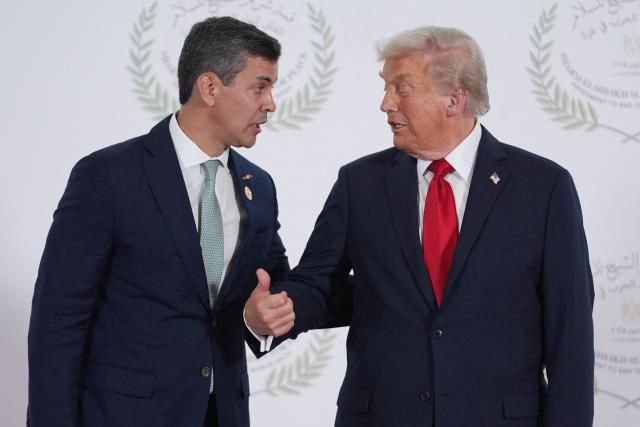 (FILES) US President Donald Trump greets Paraguay's President Santiago Pena during a summit on Gaza in Sharm el-Sheikh on October 13, 2025. Paraguay's Congress approved on March 10, 2026, an agreement with the United States that allows the presence of US military personnel in the South American country with immunity similar to diplomatic status, something the opposition criticized as a "surrender of sovereignty." (Photo by Evan Vucci / POOL / AFP)