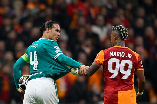 Liverpool's Dutch defender #04 Virgil van Dijk (L) and Galatasaray's Gabonese midfielder #99 Mario Lemina react during the   UEFA Champions League round of 16 first leg football match between Galatasaray SK and Liverpool FC at the Ali Sami Yen Sports Complex in Istanbul on March 10, 2026. (Photo by YASIN AKGUL / AFP)