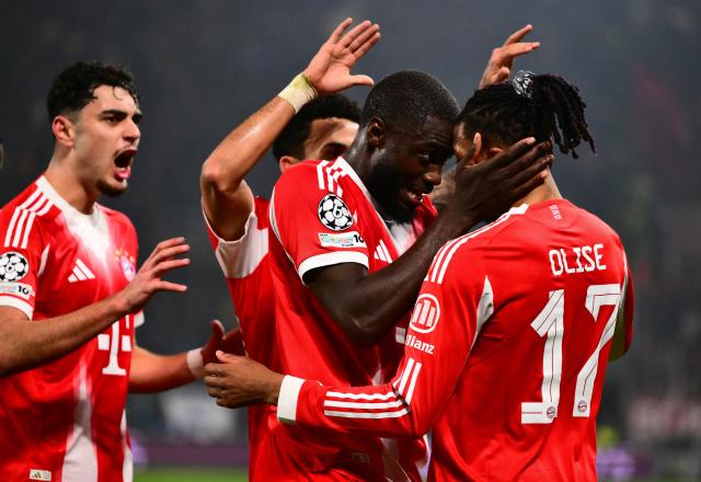 Bayern Munich's French midfielder #17 Michael Olise celebrates scoring his team's second goal with teammates during the UEFA Champions League last 16, first leg football match between Atalanta and Bayern Munich at the Gewiss stadium in Bergamo, on March 10, 2026. (Photo by Marco BERTORELLO / AFP)