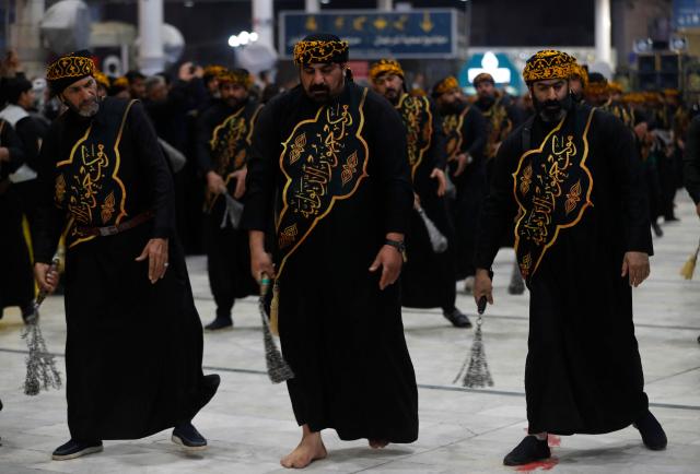 Shiite worshippers take part during a ritual commemorating the 7th century killing of Imam Ali, the cousin, son-in-law, and companion of the Prophet Muhammad, during the Muslim month of Ramadan in Iraq's holy city of Najaf on March 10, 2026. (Photo by AHMAD AL-RUBAYE / AFP)