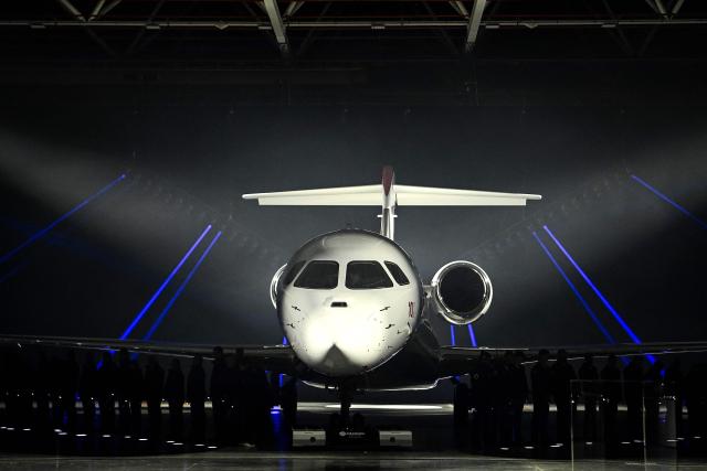 This photograph shows the Dassault Aviation's new business aircraft the Falcon 10X during its unveiling ceremony at Dassault headquarters in Bordeaux, south-western France on March 10, 2026. Master of the Rafale fighter jets, French manufacturer Dassault has unveiled the Falcon 10X, its latest private jet. Rarer and more expensive than those of its North American competitors, it is eagerly awaited for its military-grade performance in a growing market. (Photo by Christophe ARCHAMBAULT / AFP)