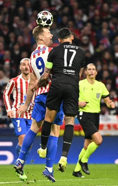 Atletico Madrid's Norwegian forward #09 Alexander Sorloth wins a header against Tottenham Hotspur's Argentinian defender #17 Cristian Romero during the UEFA Champions League last 16 first leg football match between Club Atletico de Madrid and Tottenham Hotspur at Metropolitano Stadium in Madrid on March 10, 2026. (Photo by Javier SORIANO / AFP)