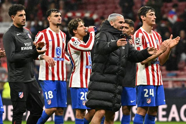 Atletico Madrid players celebrate their victory at the end of the UEFA Champions League last 16 first leg football match between Club Atletico de Madrid and Tottenham Hotspur at Metropolitano Stadium in Madrid on March 10, 2026. (Photo by Javier SORIANO / AFP)