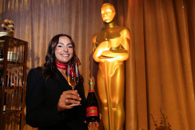 Piper-Heidsieck brand ambassador Marie-Noura Aazizou poses with a glass of Champagne at the 98th Oscars Governors Ball preview at the Ray Dolby Ballroom in Hollywood, California, on March 10, 2026. Austrian Chef Wolfgang Puck unveiled his menu for the Academy's official post Oscars celebration. (Photo by VALERIE MACON / AFP)