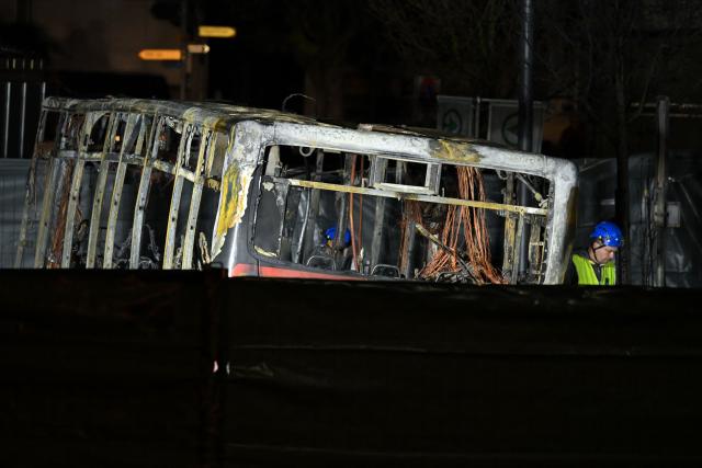 Forensic officers work in a cordoned-off area inside a bus that caught fire, killing at least six people and injuring five others in what police said may have been a deliberate act, in the town of Kerzers, western Switzerland, on March 11, 2026. A bus caught fire in western Switzerland on March 10 killing at least six people and injuring five others in what police said may have been a deliberate act. The fire broke out on the bus in the main street of the small town of Kerzers, around 20 kilometres (12 miles) west of the Swiss capital Bern, at about 6:25 pm (1725 GMT). (Photo by Fabrice COFFRINI / AFP)