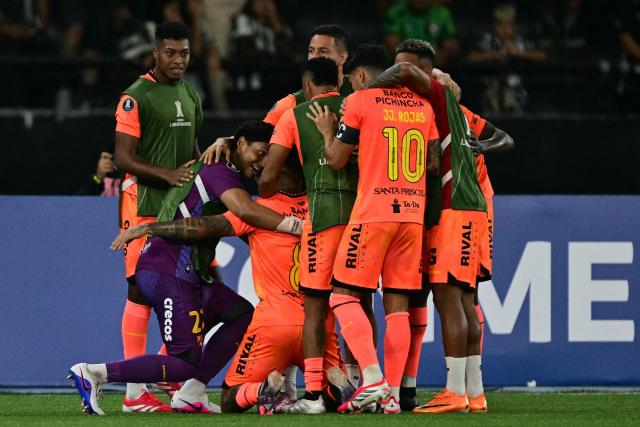 Barcelona players celebrate after scoring the opening goal during the Copa Libertadores phase three second-leg football match between Brazil's Botafogo and Ecuador's Barcelona at the Nilton Santos Stadium in Rio de Janeiro, Brazil on March 10, 2026. (Photo by Pablo PORCIUNCULA / AFP)