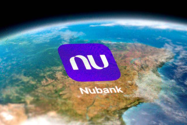 (FILES) In this photo illustration, the app of the Brazilian bank Nubank is displayed on a cell phone in Rio de Janeiro, Brazil, on October 1, 2024. Nubank CEO David Velez, whose massive Brazil-based digital bank is on the verge of entering the prized US market, hailed a "positive" regulatory climate under President Donald Trump in an interview with AFP. (Photo by MAURO PIMENTEL / AFP)
