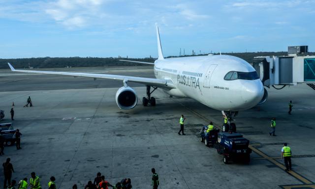 A Plus Ultra Airlines plane taxis after a flight from Spain at Simon Bolivar International Airport in Maiquetia, Venezuela on March 10, 2026. Flights from Spain arrive in Venezuela after the capture of Nicolas Maduro in early January 2026 during a US military operation. (Photo by AFP)