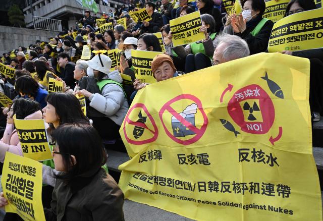Protesters hold a banner against nukes during an anti-nuclear rally to mark the 15th anniversary of Japan's Fukushima nuclear disaster in Seoul on March 11, 2026. (Photo by Jung Yeon-je / AFP)