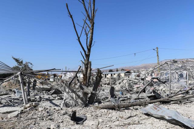A photograph shows the aftermath of an Israeli airstrike that targeted the village of Temnin in Lebanon's Bekaa Valley on March 11, 2026. Lebanon was drawn into the Middle East war last week when Hezbollah attacked Israel in response to the killing of the Iranian supreme leader in US-Israeli strikes. Israel, which kept up strikes targeting Hezbollah despite a 2024 ceasefire, has since launched attacks across Lebanon and sent ground troops into border areas. (Photo by Nidal SOLH / AFP) / Attention editors: AFP covers the war in the Middle East through its extensive regional network, including bureaus in Tehran, Jerusalem, and several neighboring countries. Since the start of the conflict, journalists have been working under increasingly restrictive conditions. Authorities in several countries have limited reporters' movements, photo and live video coverage from sensitive locations. Some governments and armed groups have banned images of missile or drone strikes and other security-related sites. / 