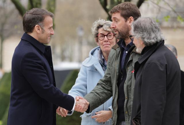 French President Emmanuel Macron (L) greets representatives of victims' associations as he arrives for a ceremony paying tribute to the victims of terrorism at Les Invalides in Paris on March 11, 2026. (Photo by Ludovic MARIN / POOL / AFP)