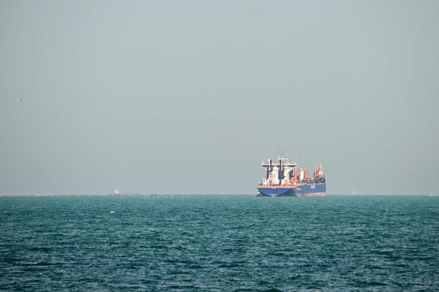 A commercial vessel is pictured offshore in Dubai on March 11, 2026. New attacks hit three commercial ships in the Gulf on March 11, with one of the vessels in flames as Iran pressed its campaign against its oil-exporting neighbours, threatening shipping in the Strait of Hormuz and plunging the global energy economy into crisis. (Photo by AFP) / Attention editors: AFP covers the war in the Middle East through its extensive regional network, including bureaus in Tehran, Jerusalem and several neighboring countries.Since the start of the conflict, journalists have been working under increasingly restrictive conditions. Authorities in several countries have limited reporters movements, photo and live video coverage from sensitive locations. Some governments and armed groups have banned images of missile or drone strikes and other security-related sites. / 
